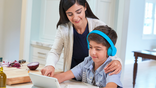 Mother teaching son using tablet